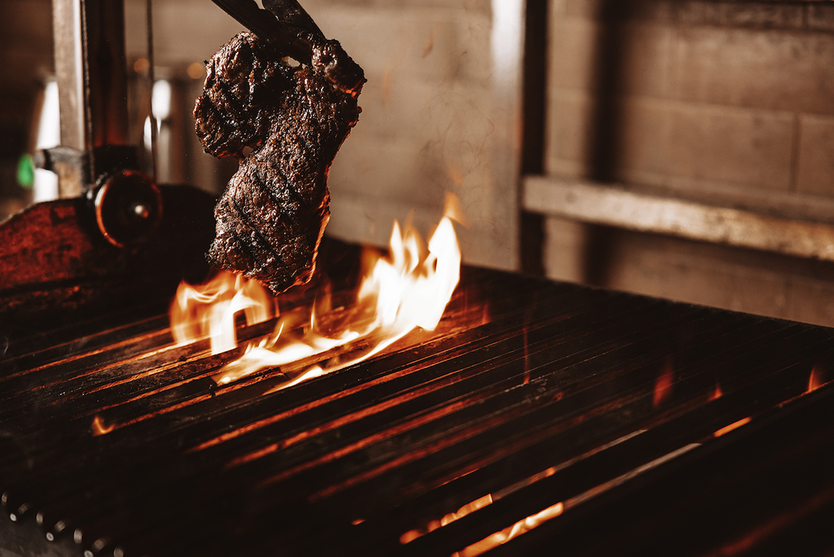 Steak preparation on the wood-fire grill at Flamant. | Photo by Samantha Marie