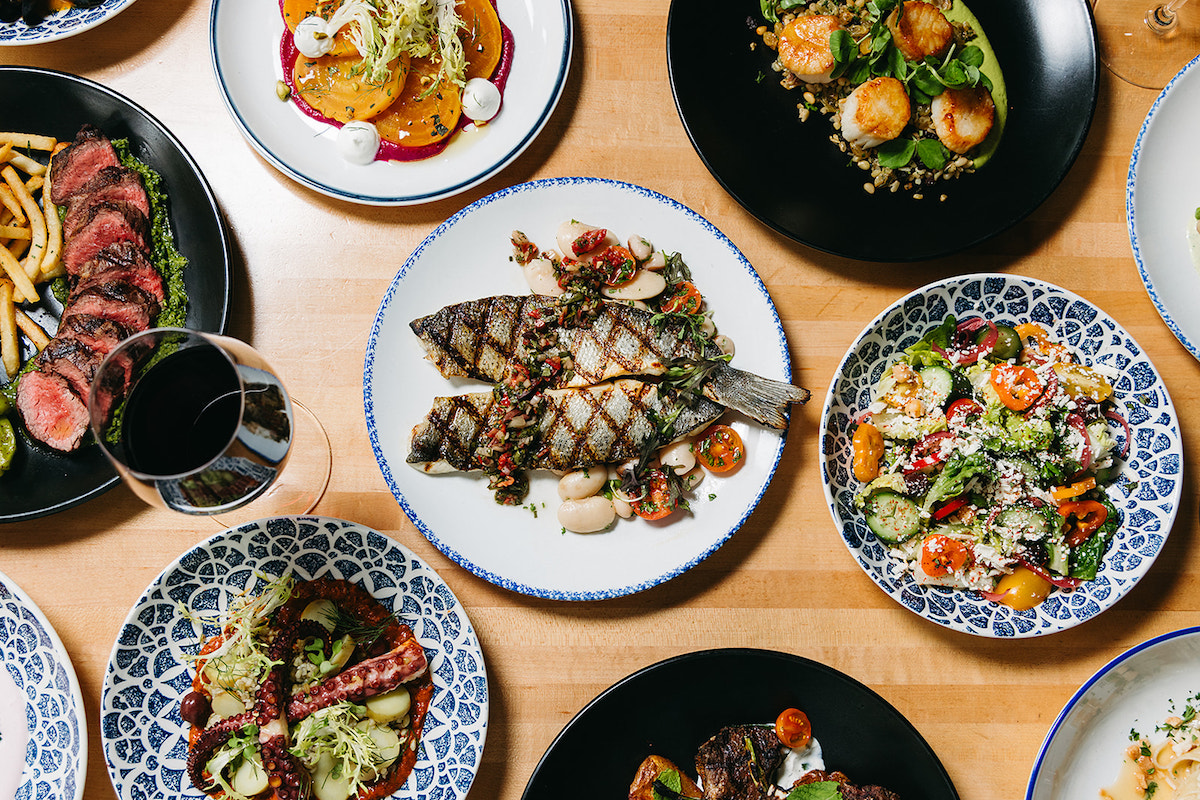 A spread of dishes, including whole fish, at Sachet. | Photo by Sachet