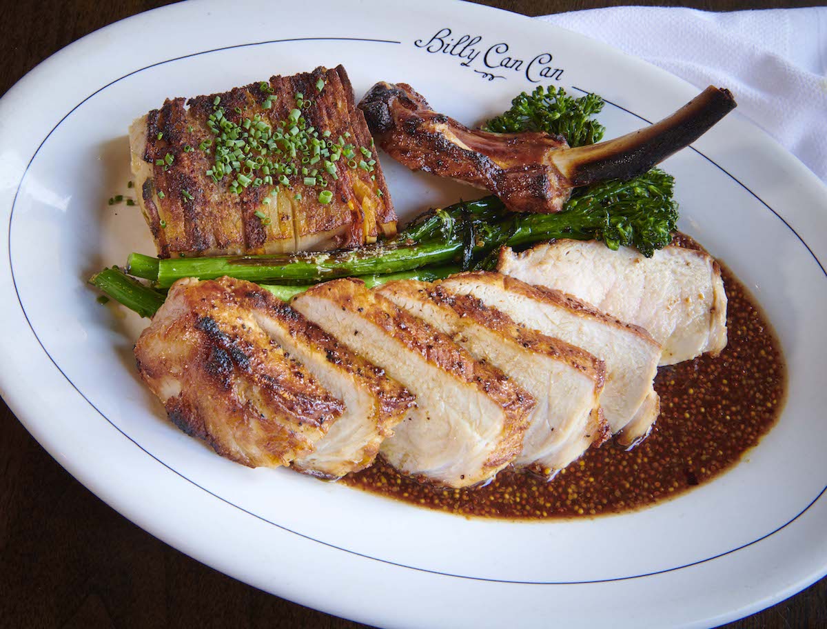BILLY_CAN_CAN pork chop high res - DiningOut Dallas Whiskey-brined, bone-in pork chop with loaded potato pavé, charred broccolini and mustard jus at Billy Can Can. | Photo by Billy Can Can
