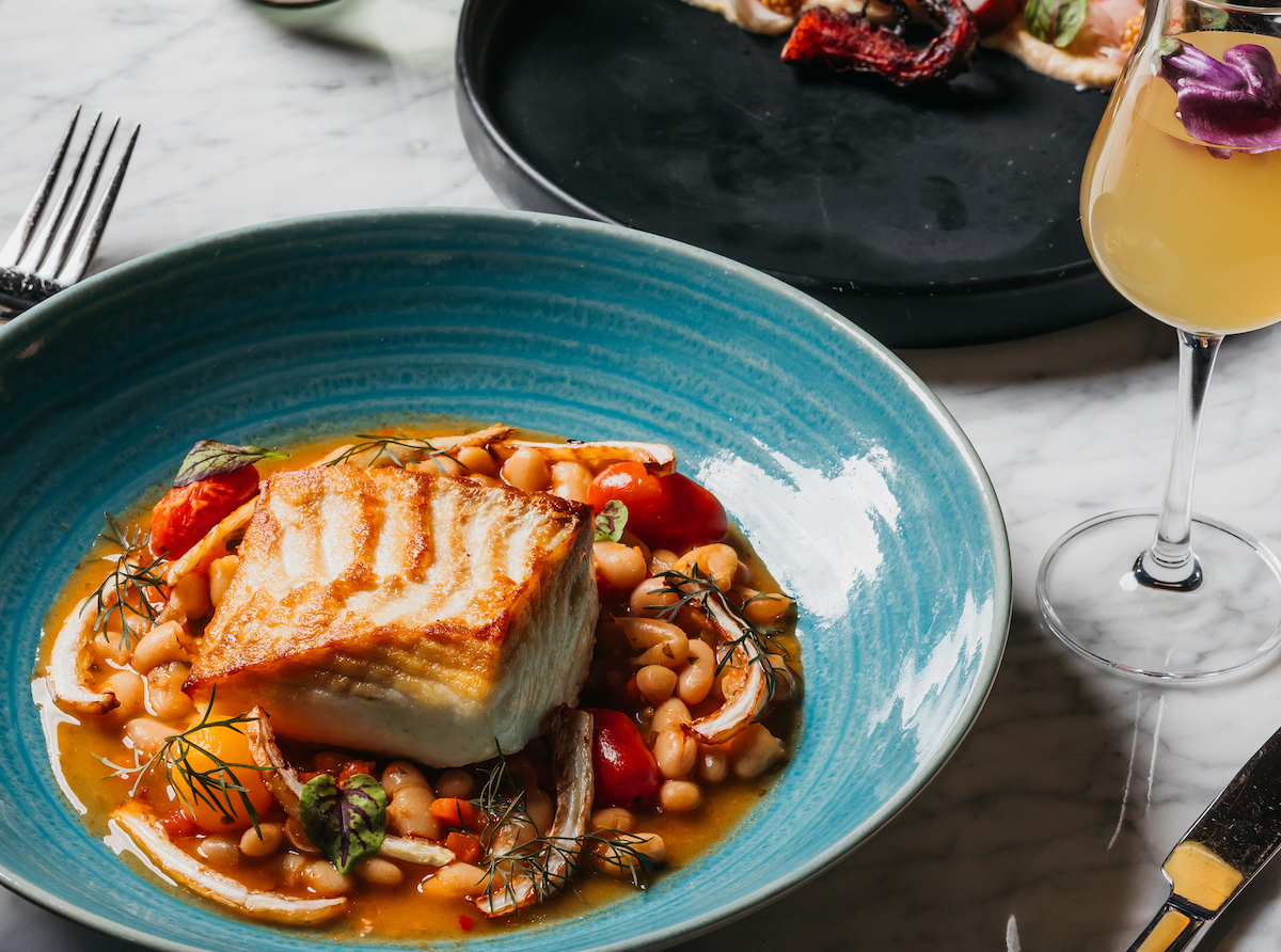 Emilias PC Thomas Welch - DiningOut Dallas Seared halibut with stewed white beans, melted tomatoes, and charred fennel at Emilia's. | Photo by Thomas Welch